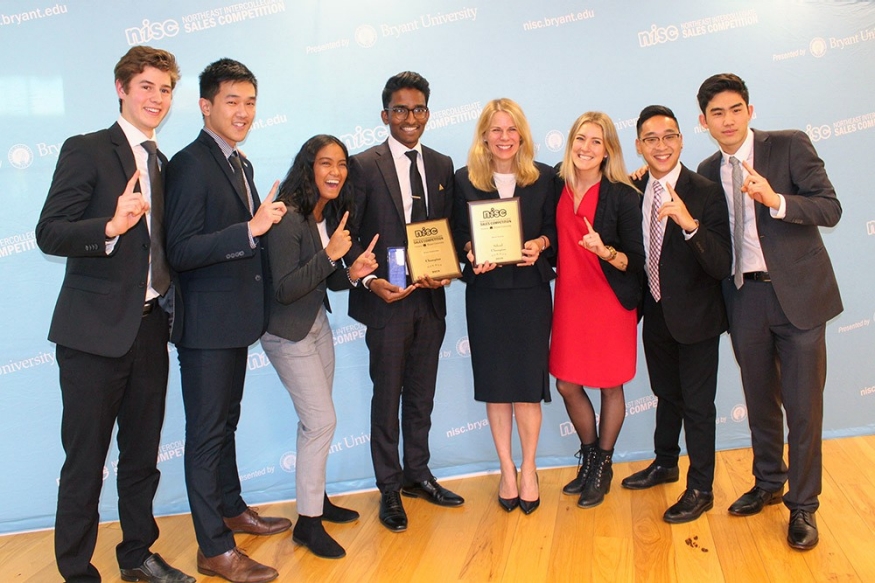 Sales Leadership Team posing for a photo holding award certificate