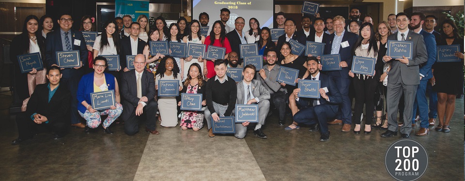 A large group of proud people posing with navy blue awards  